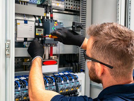 Electrician Working at Electric Panel — Port Charlotte, FL — Air Technicians Inc
