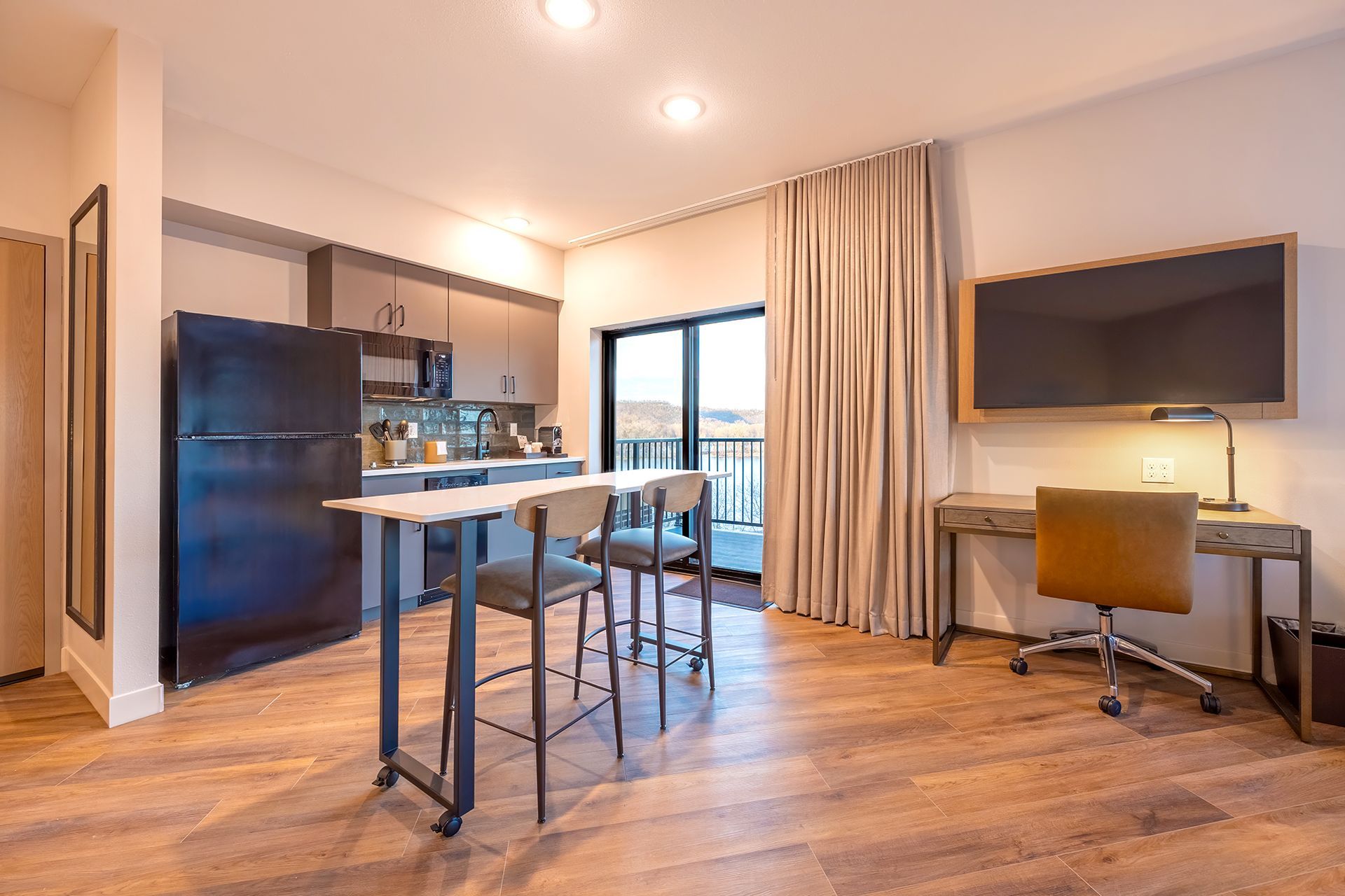 Modern studio apartment with kitchen, breakfast bar, and desk. Includes a balcony with river and bluff views.