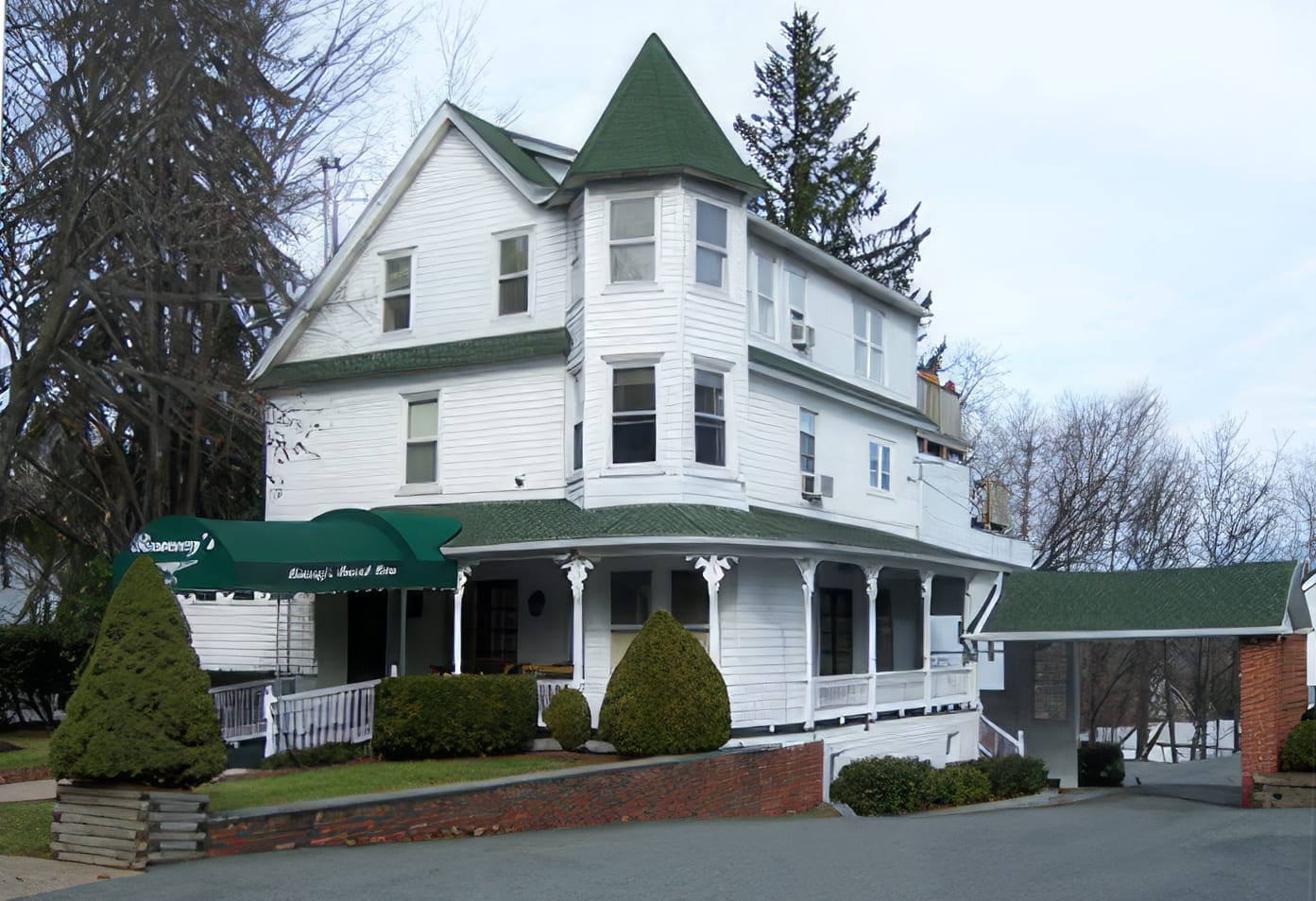 A large white house with a green roof