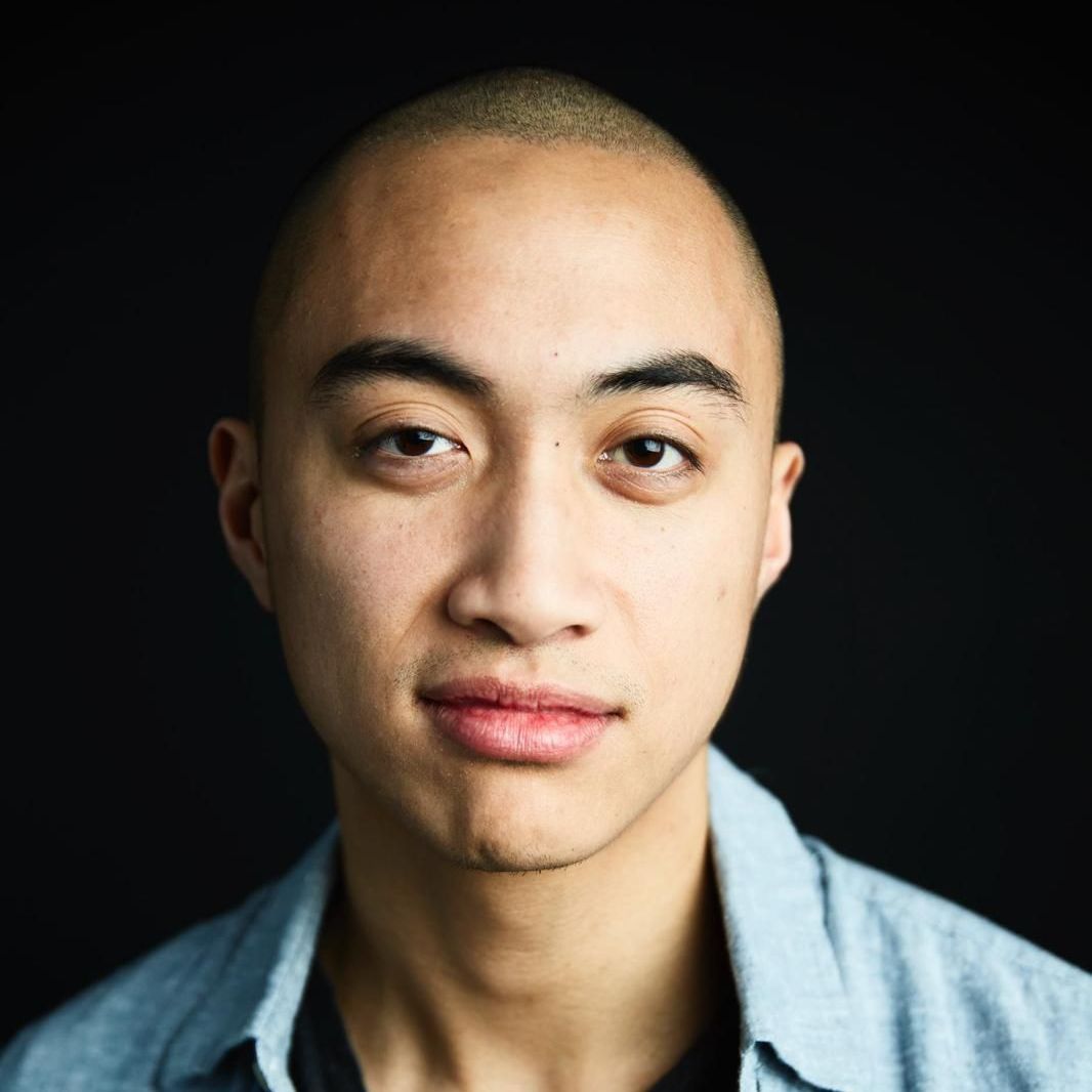 A close up of a man 's face with a black background