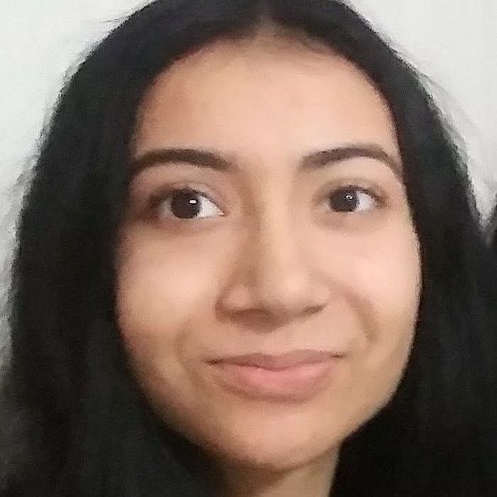 A close up of a woman 's face with long black hair.