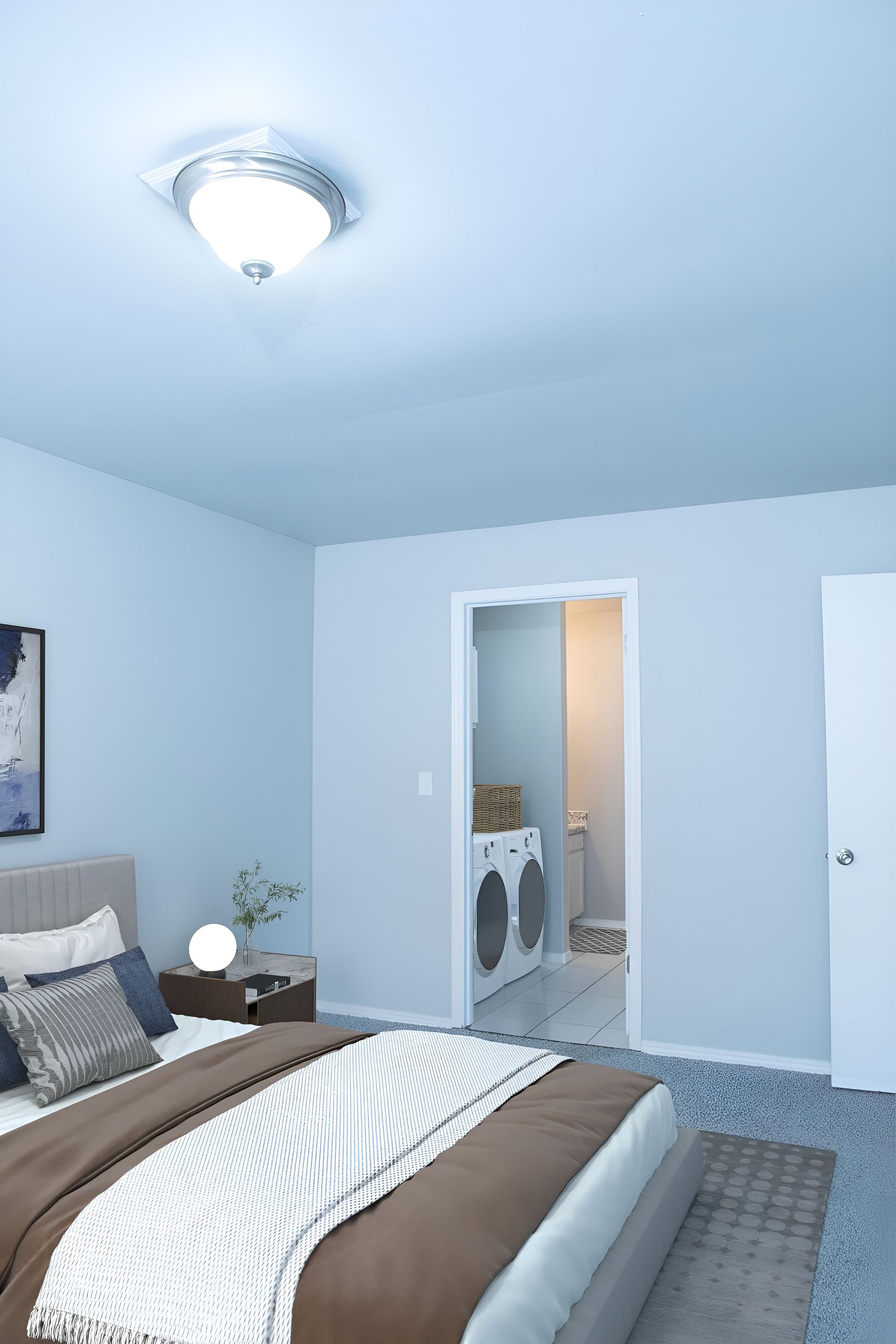 a bedroom with a bed and a washer and dryer