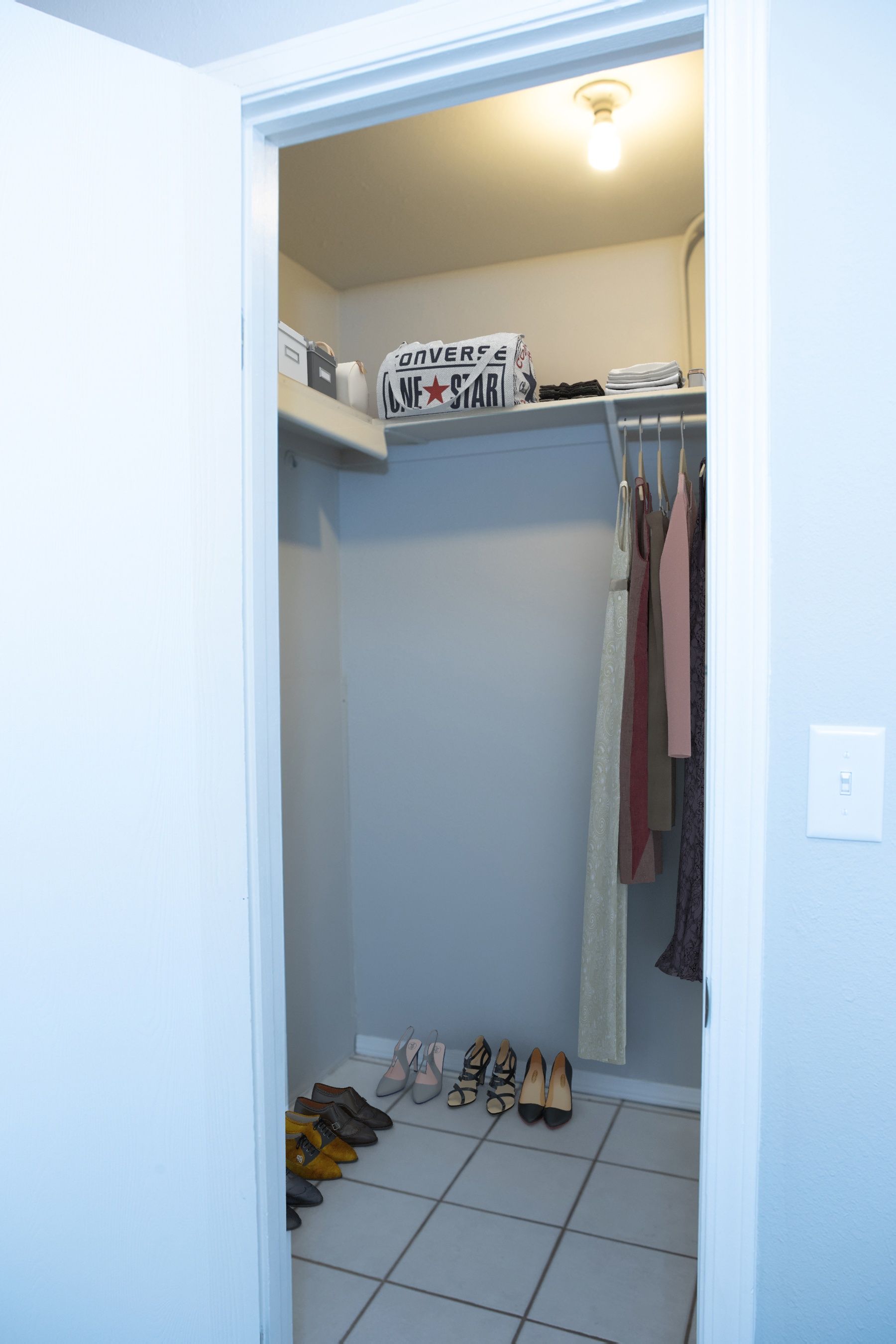 a closet with a sign on the shelf that says converse all star