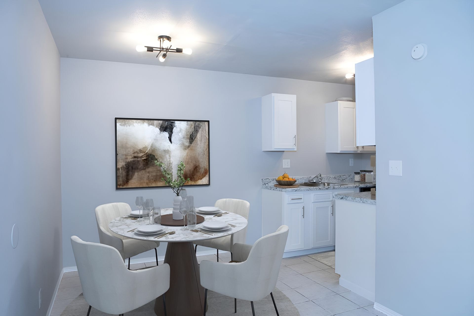 a dining room with a table and chairs and a painting on the wall