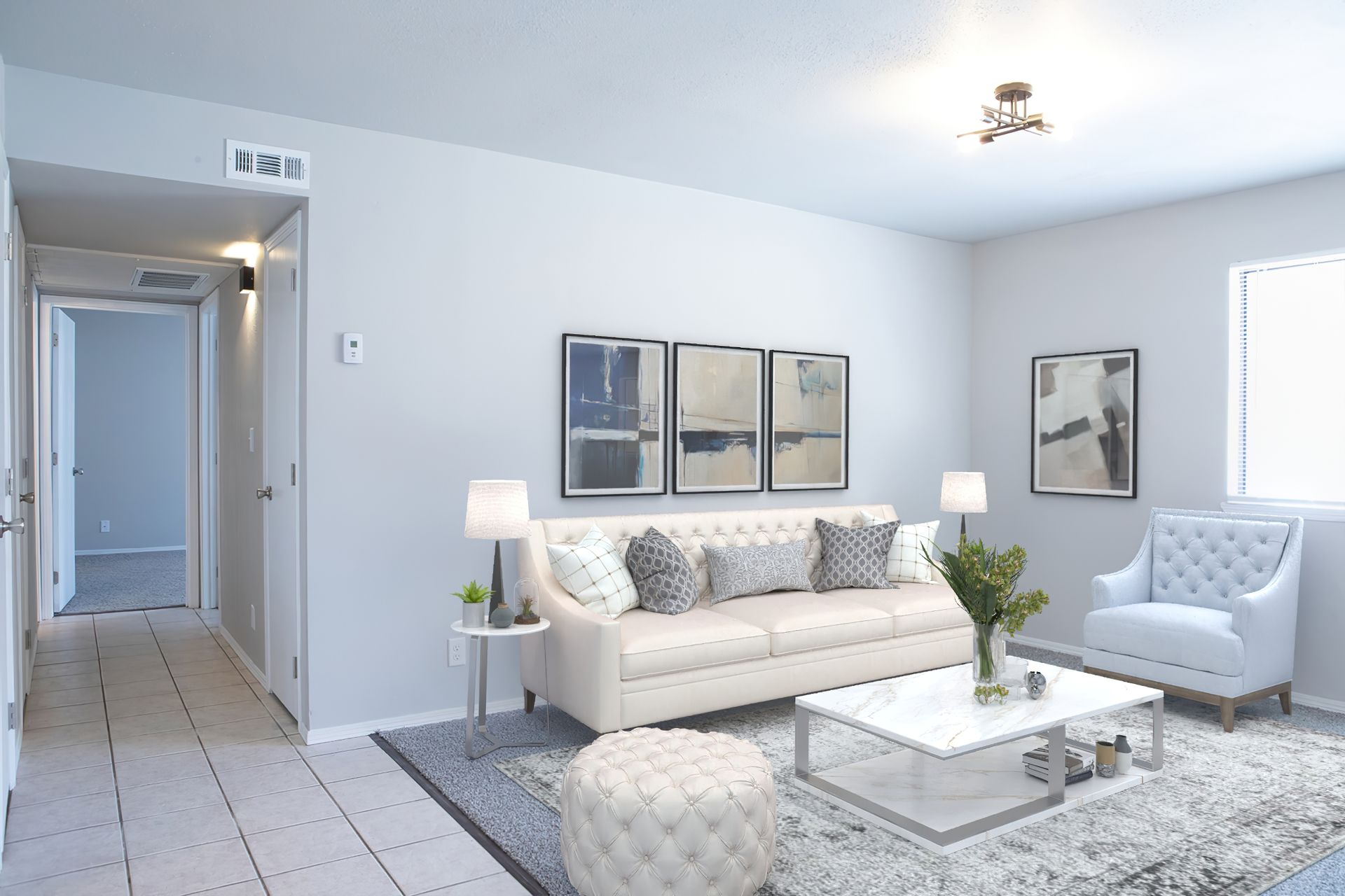 a living room with a white couch and a white coffee table