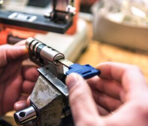 A person is working on a lock with a tool.