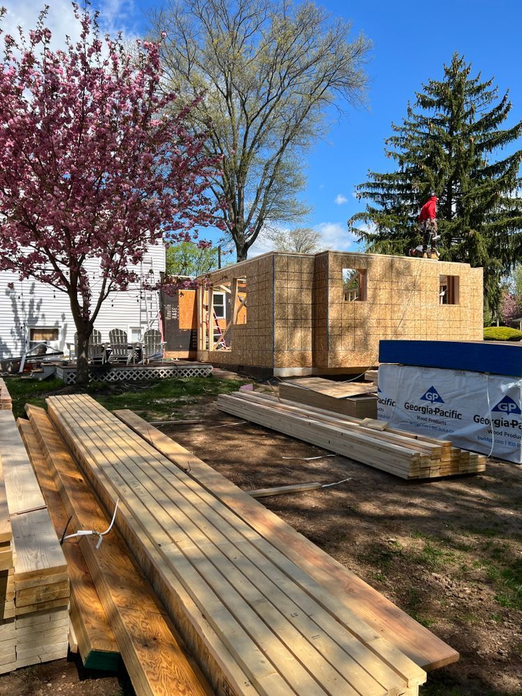 A house is being built in a park with a lot of wood.