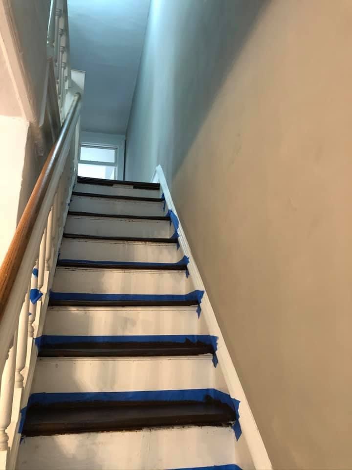 A set of stairs with blue tape on the steps.