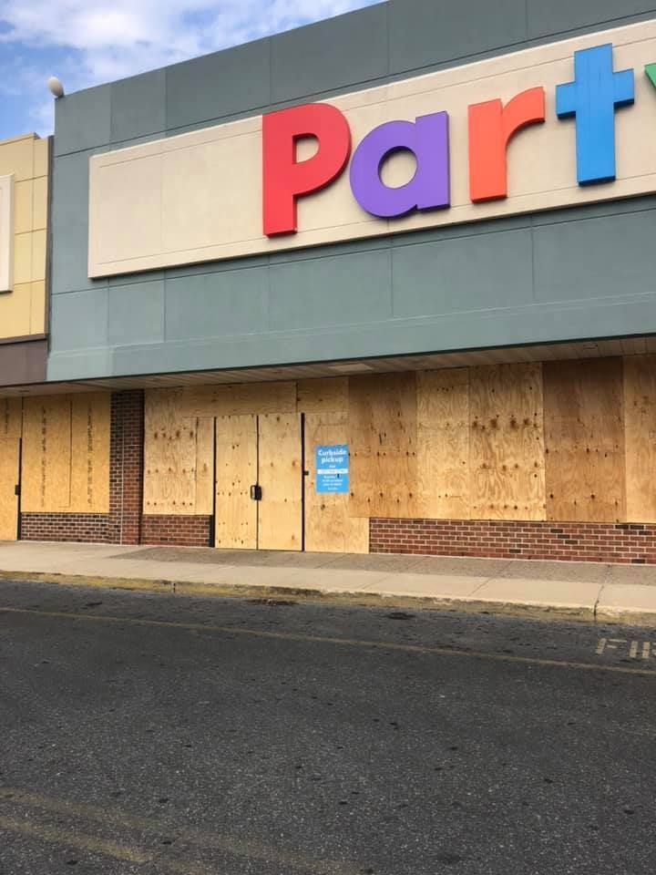 A party store that is boarded up and closed