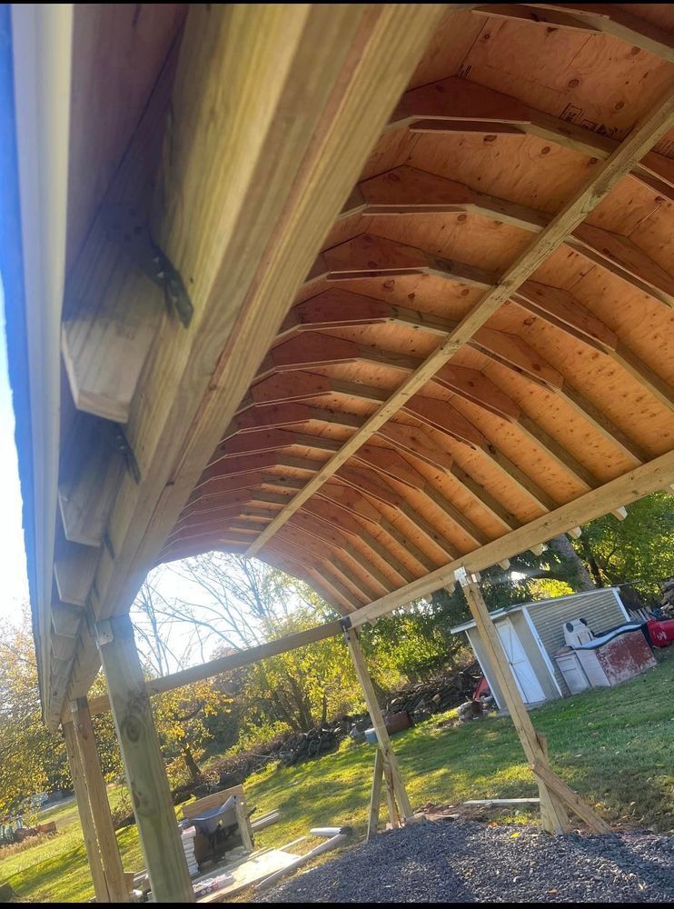 The roof of a wooden structure is being built.