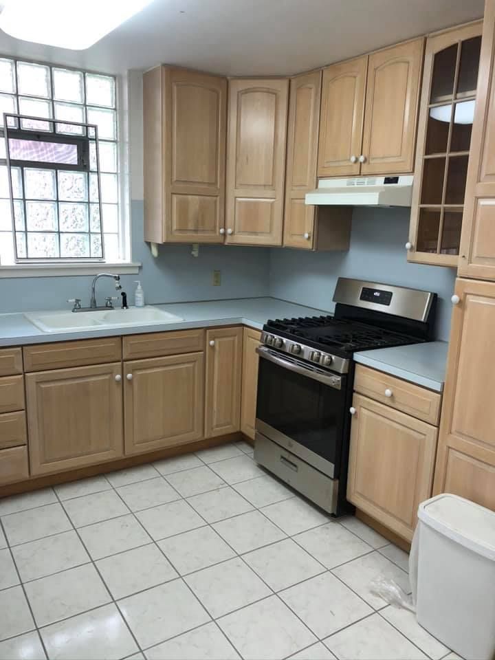 A kitchen with stainless steel appliances and wooden cabinets