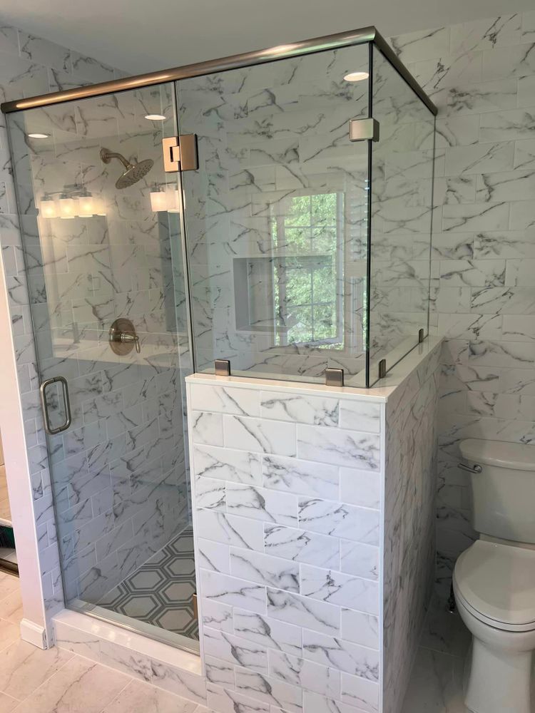 A bathroom with a walk in shower and a toilet.