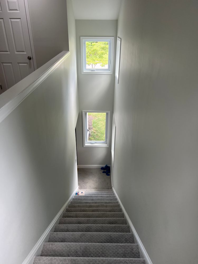 A staircase leading up to the second floor of a house with a window.