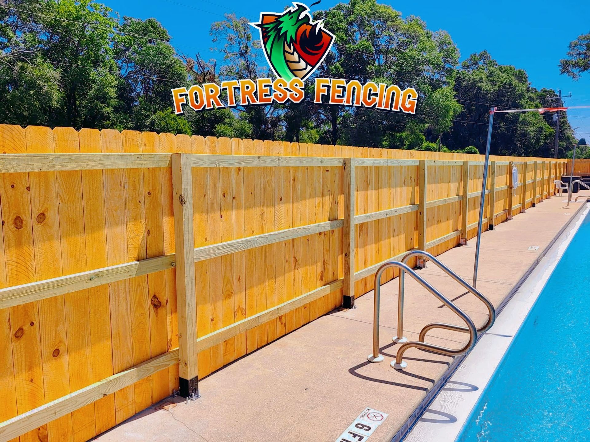 Wooden fence surrounding a pool, with the