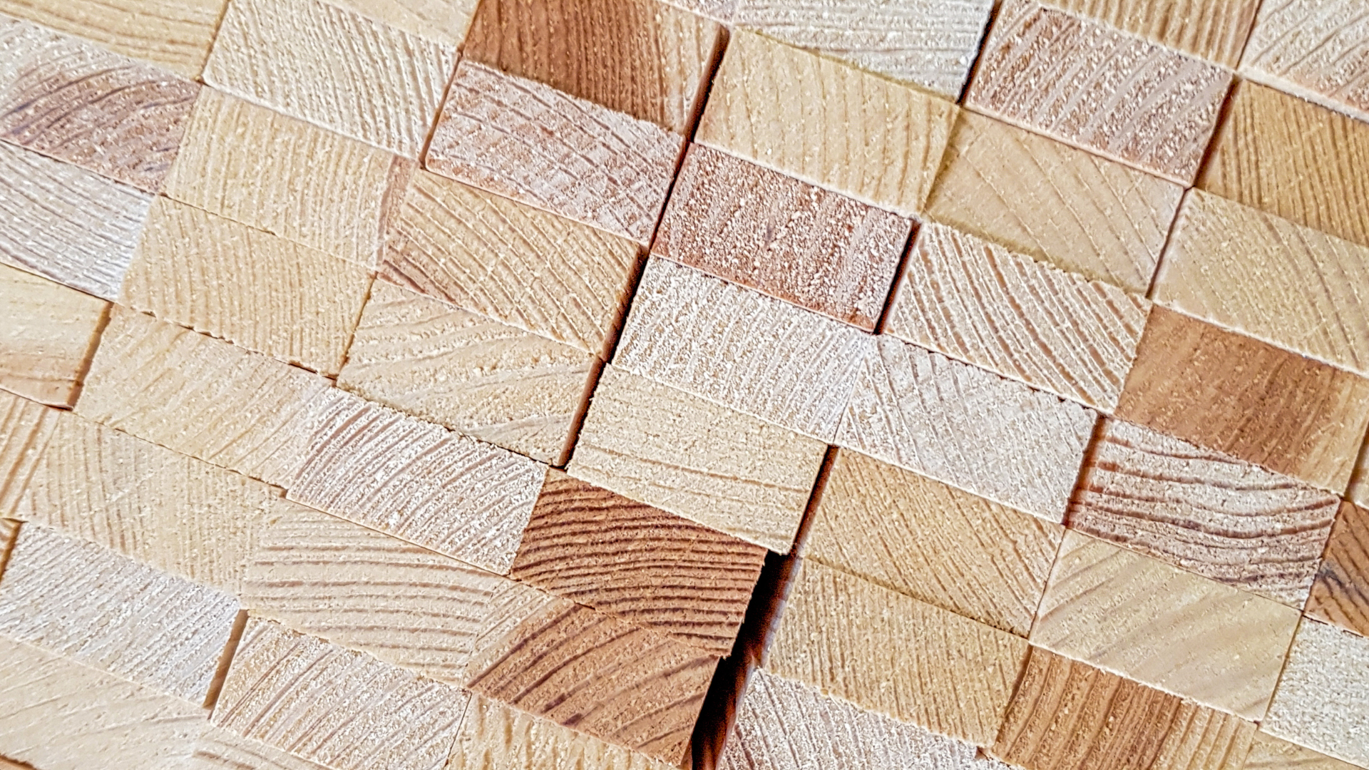 A close up of a pile of wooden blocks stacked on top of each other.