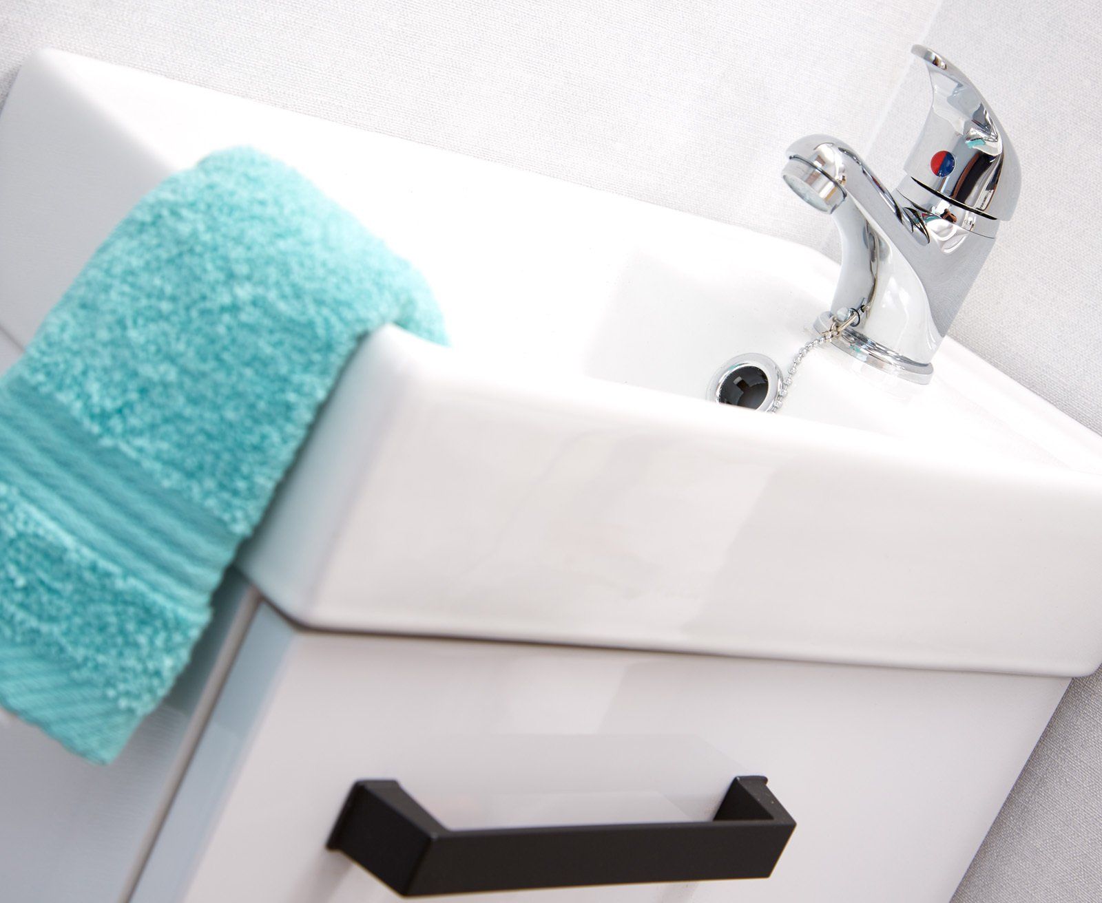 A bathroom sink with a blue towel on it