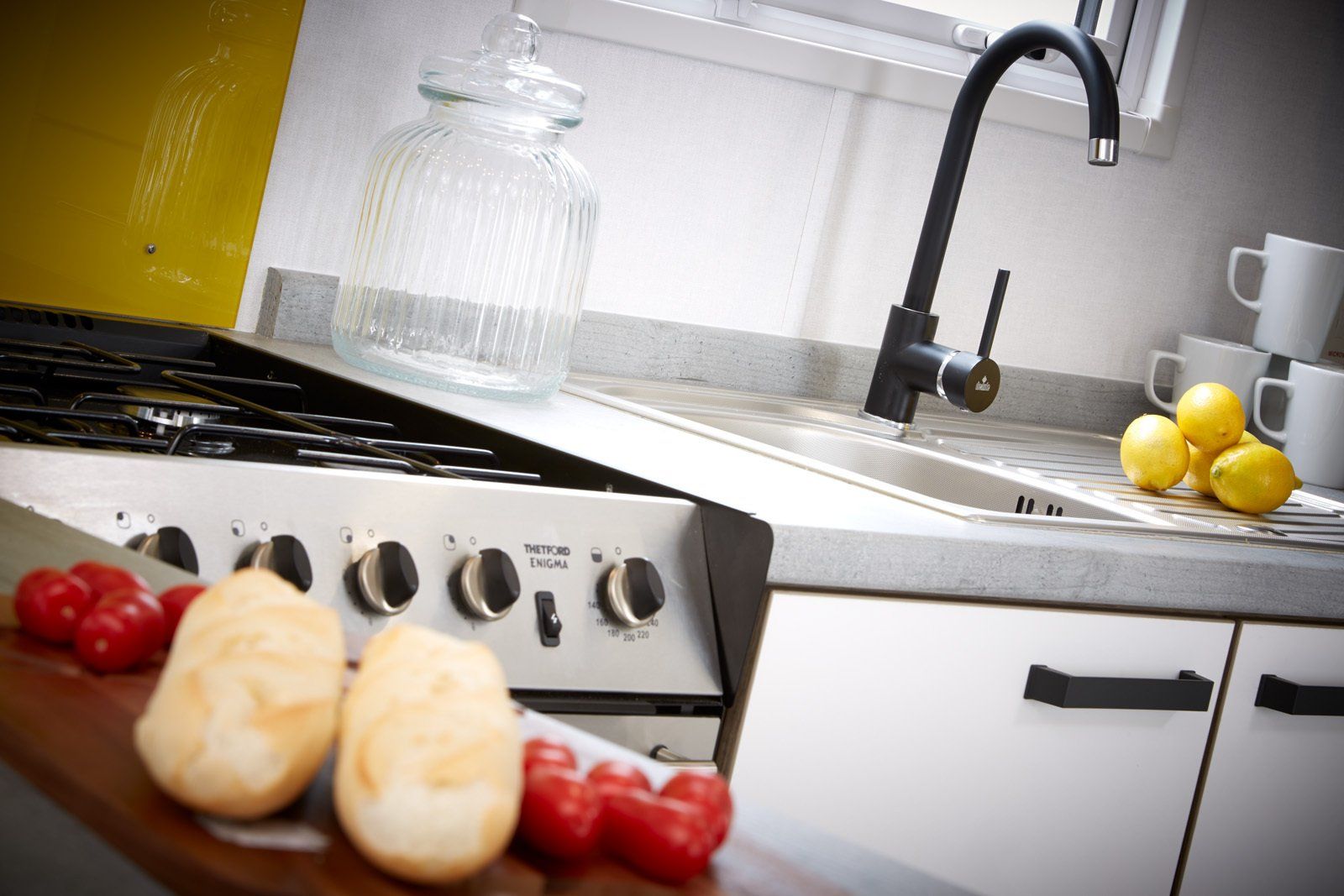 A kitchen with a stove top oven and a sink