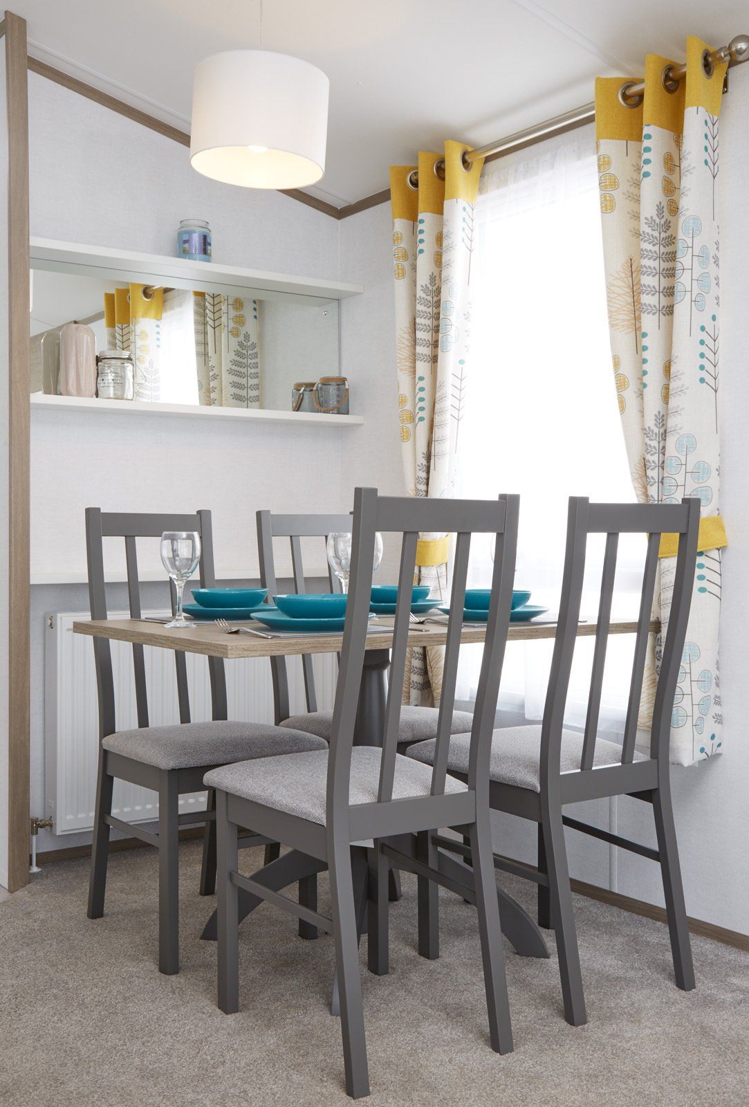 A dining room with a table and chairs and a window