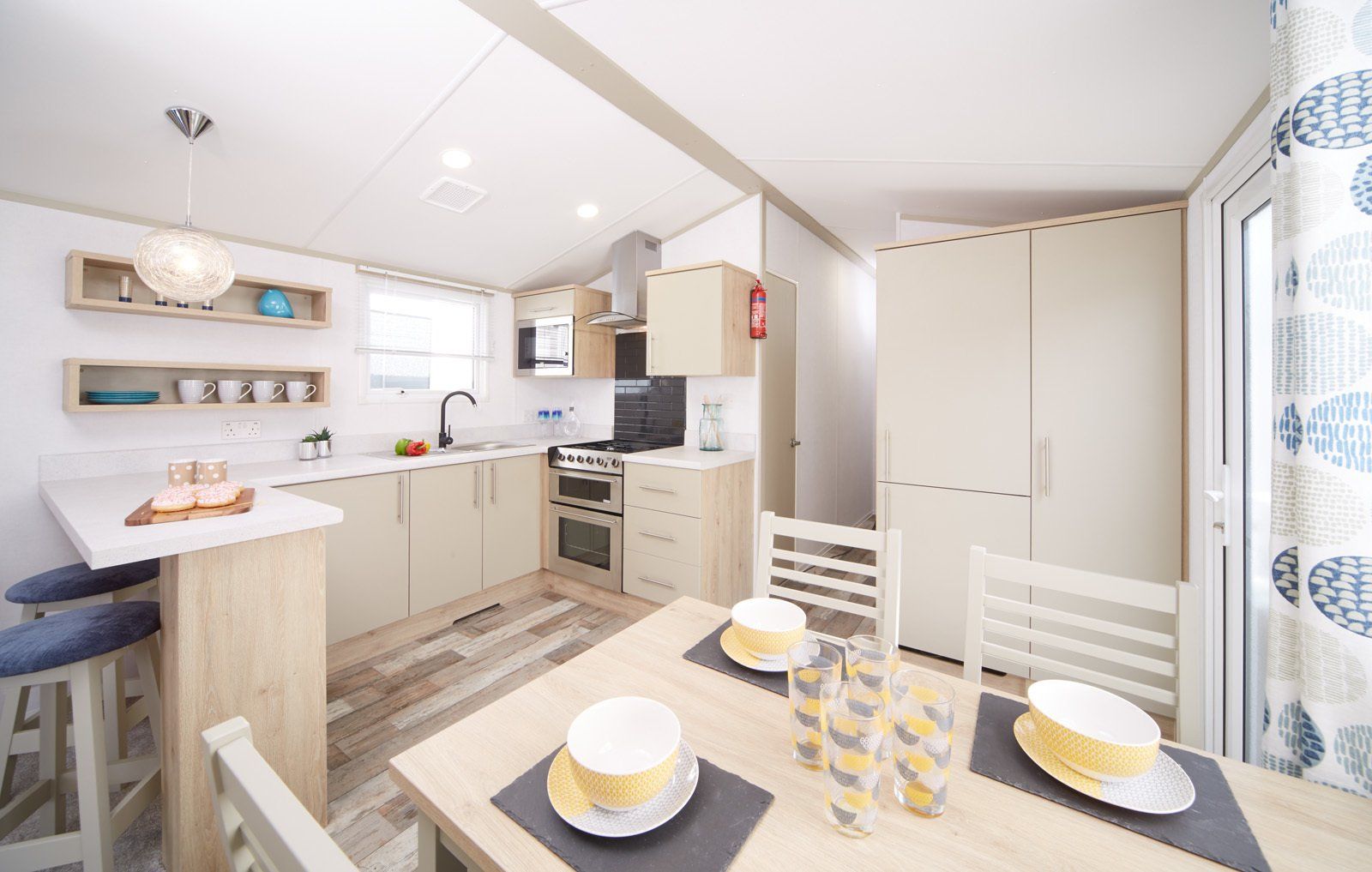 A kitchen and dining room in a mobile home with a table and chairs.