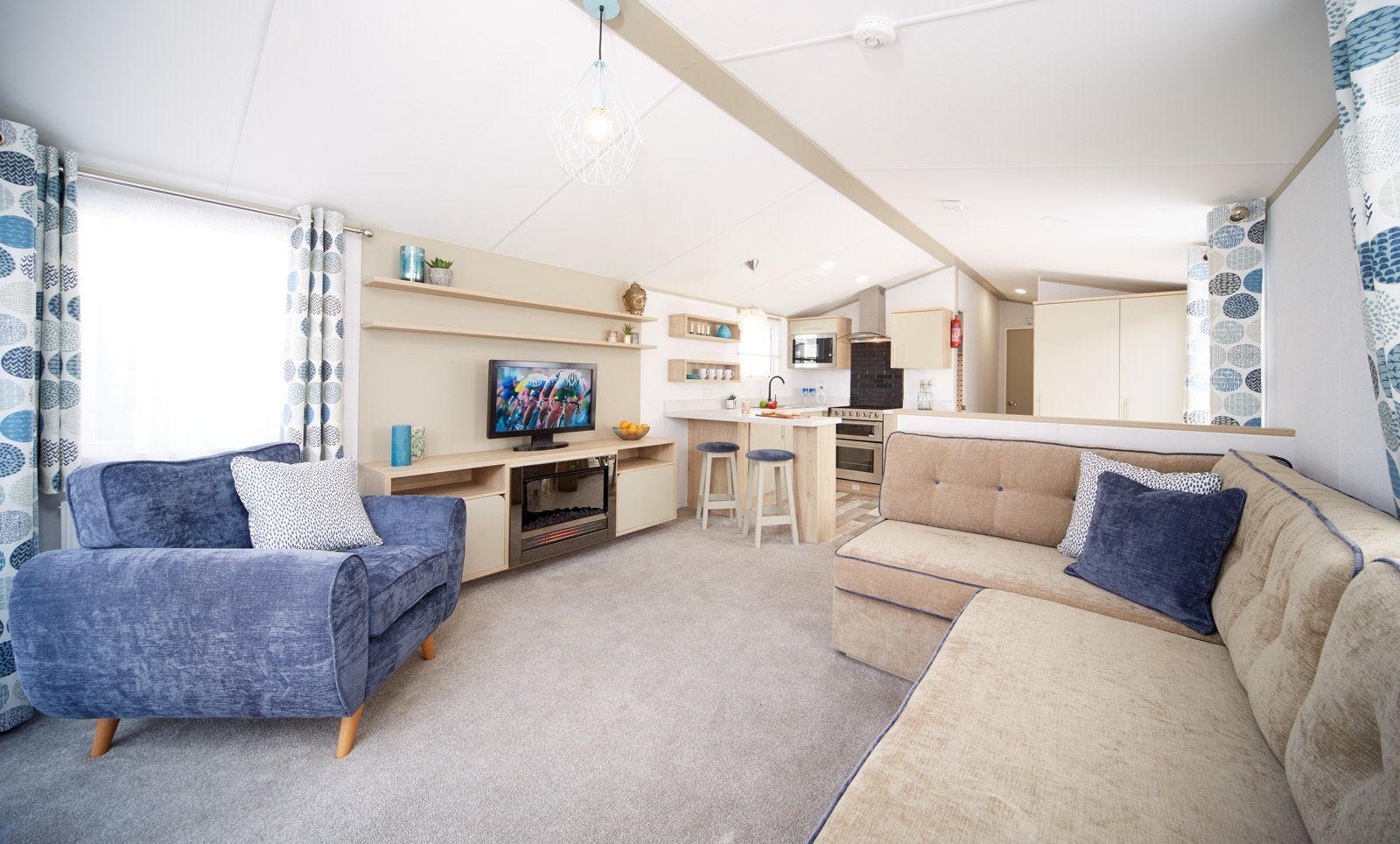 A living room with a couch , chair , and television.