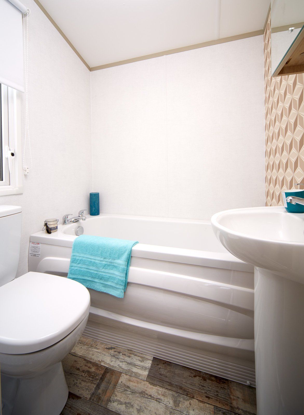 A bathroom with a toilet , sink and bathtub.