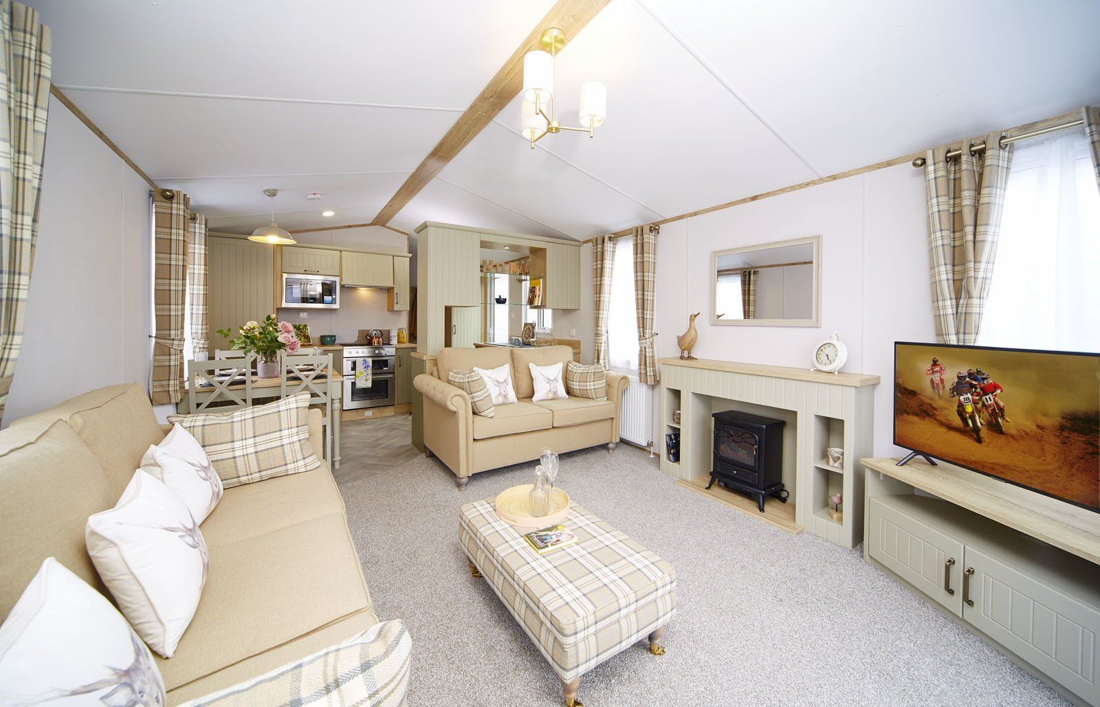 A living room with a couch , coffee table , fireplace and television.