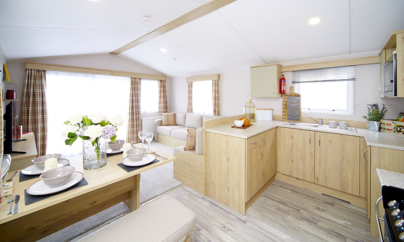 A kitchen and dining room in a mobile home.