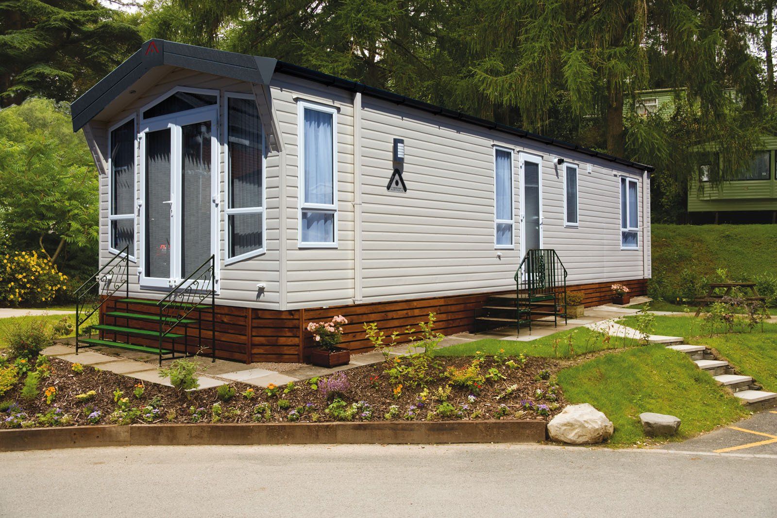 A mobile home is parked on the side of the road.