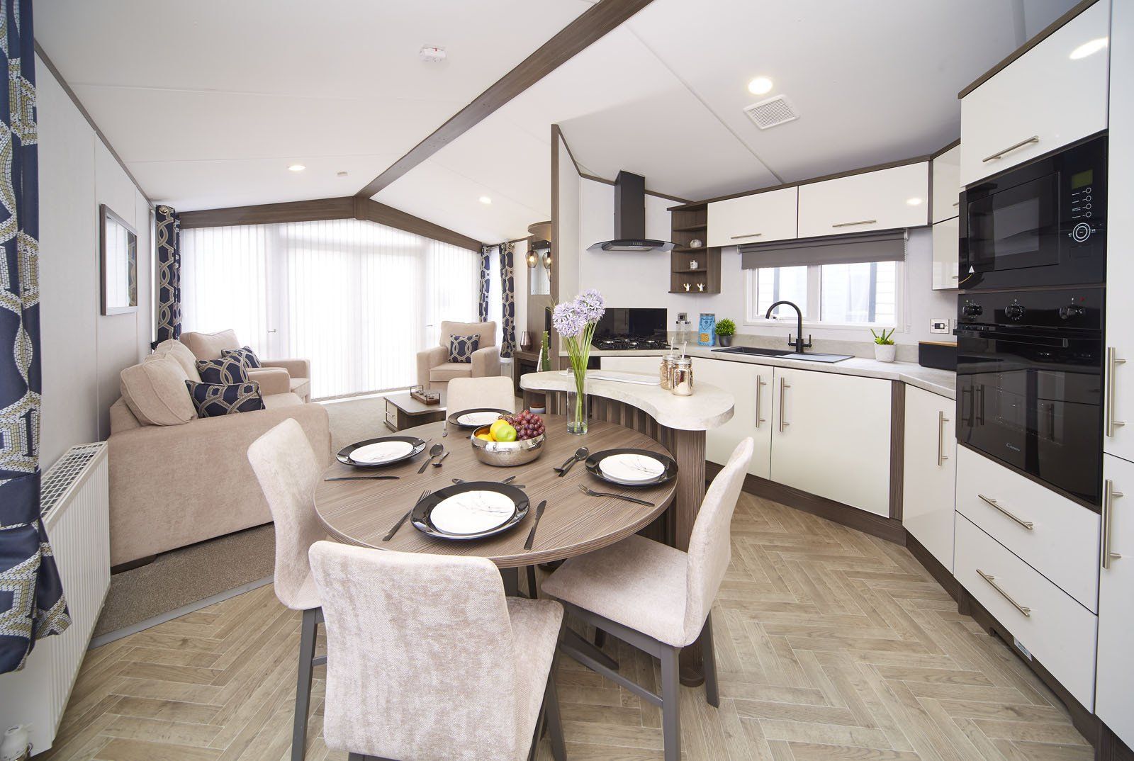 A kitchen with a dining table and chairs in it.