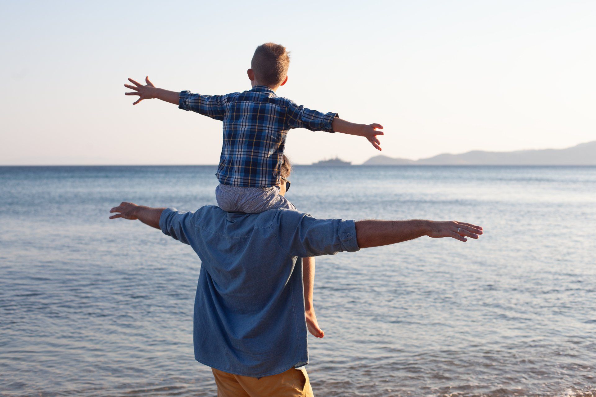 A farther and son enjoying a holiday on the beach