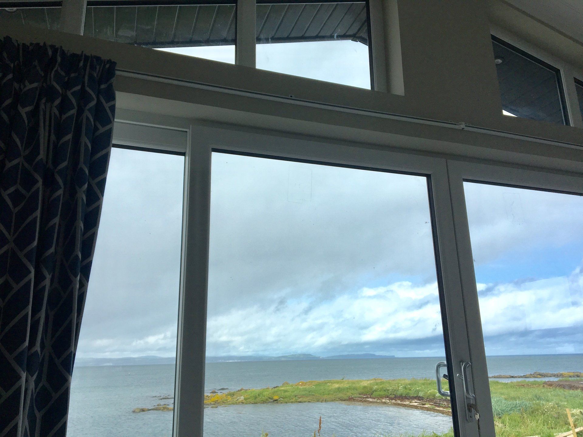 A large window with a view of the ocean