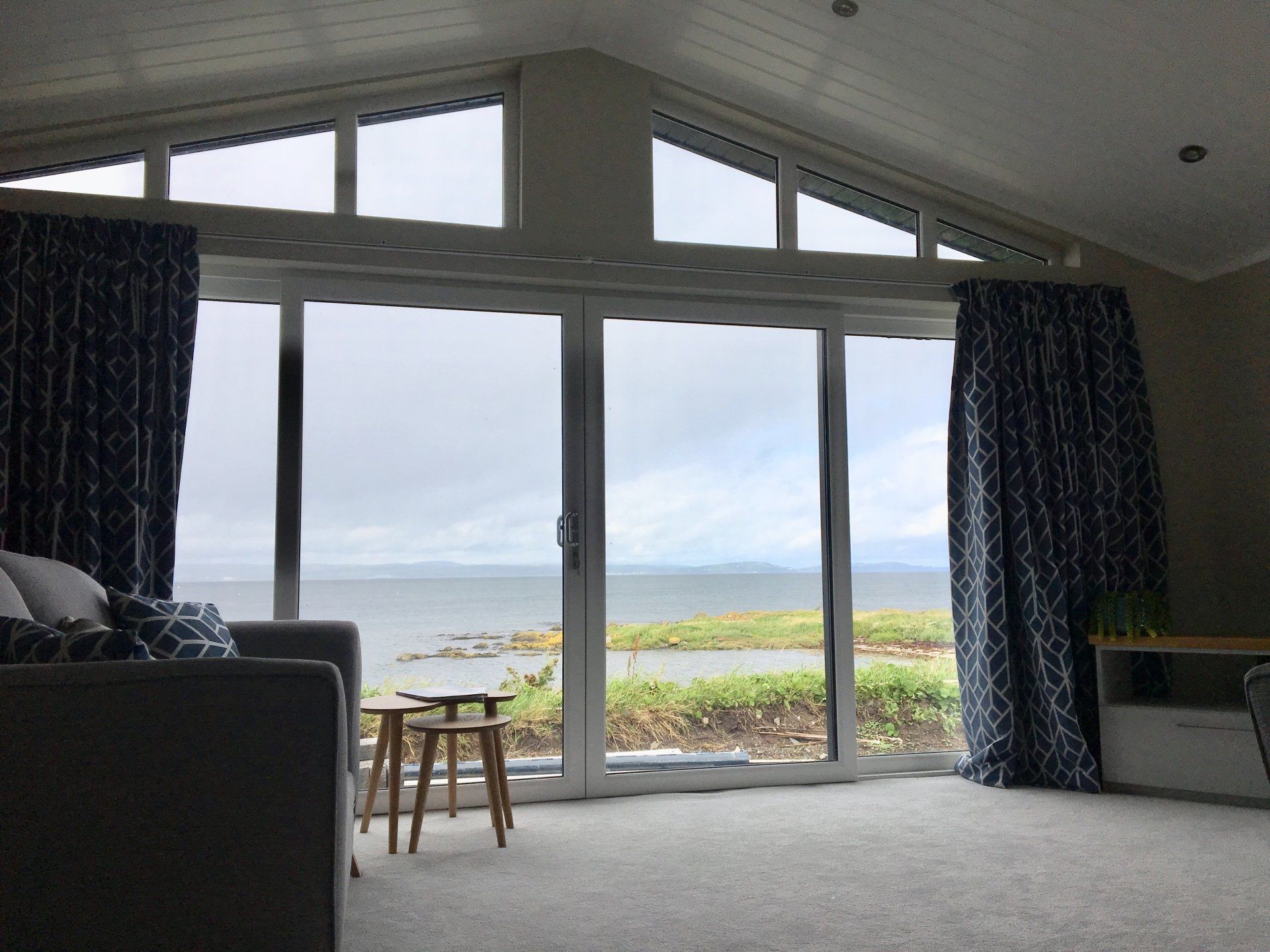 A living room with a view of the ocean