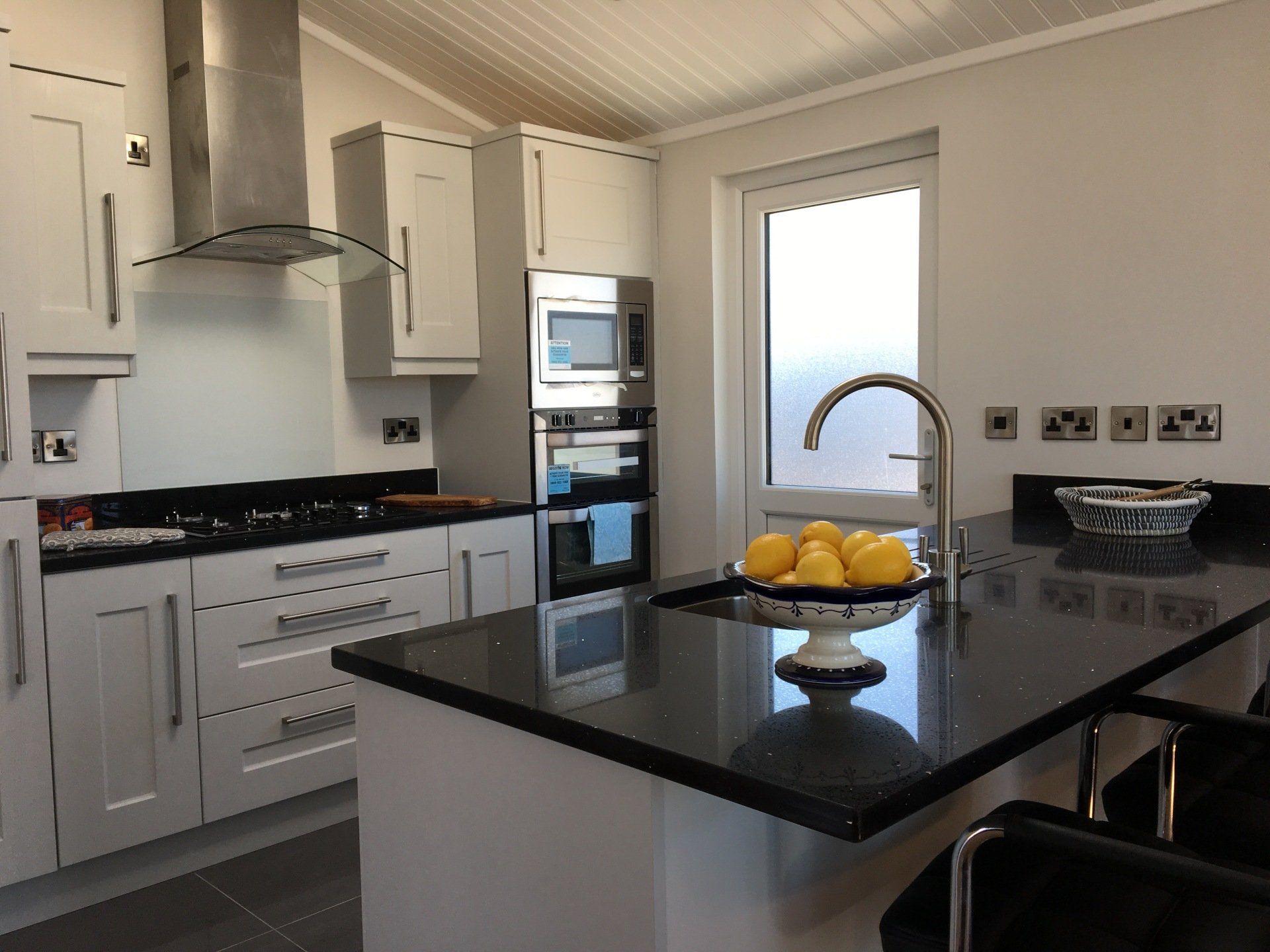 A kitchen with a bowl of lemons on the counter