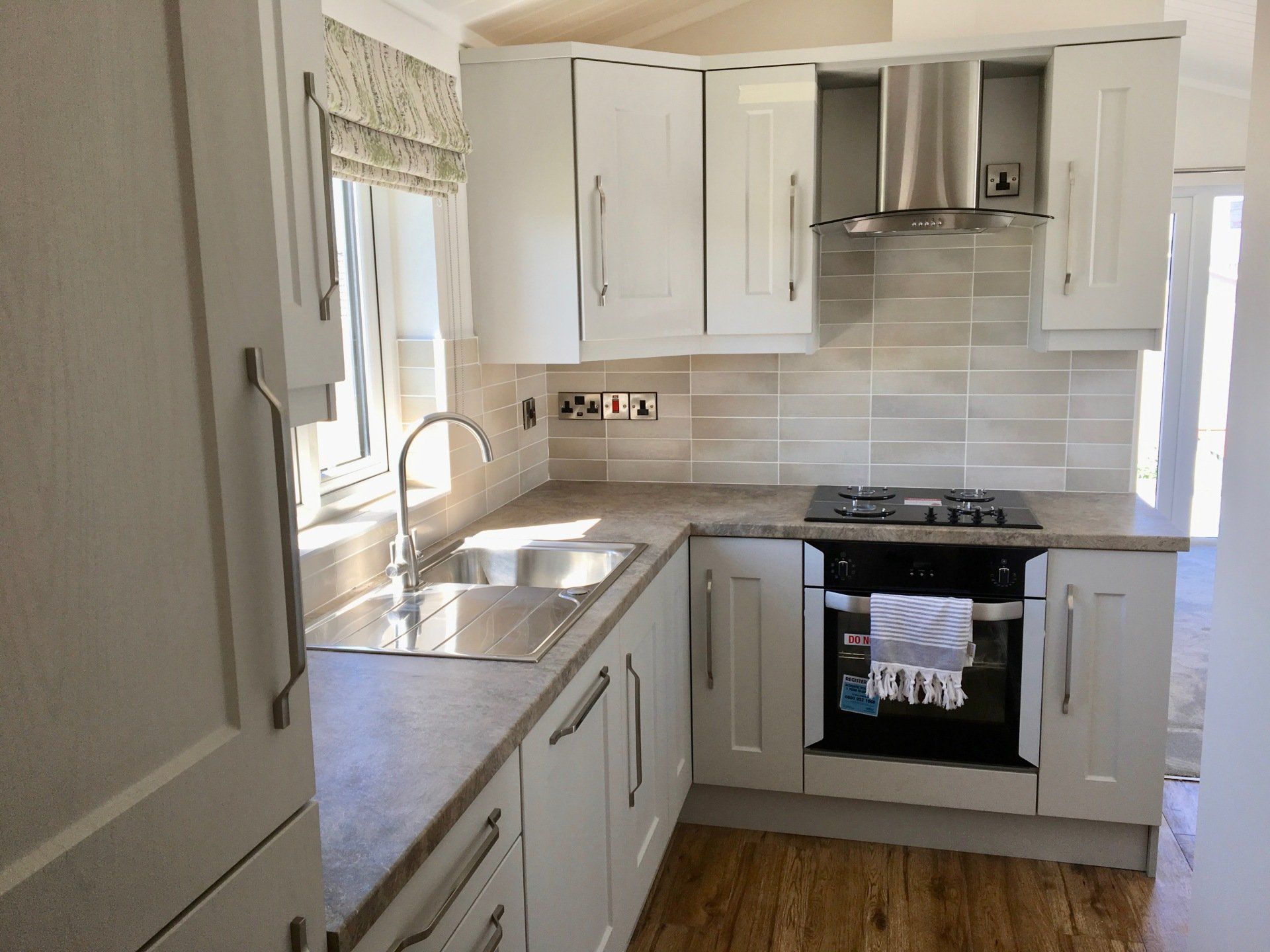 A kitchen with white cabinets and stainless steel appliances