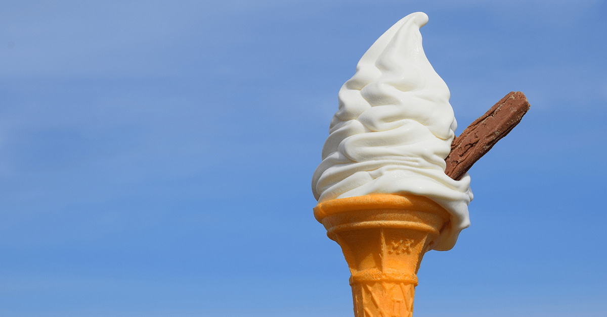 A cone of ice cream against a blue sky