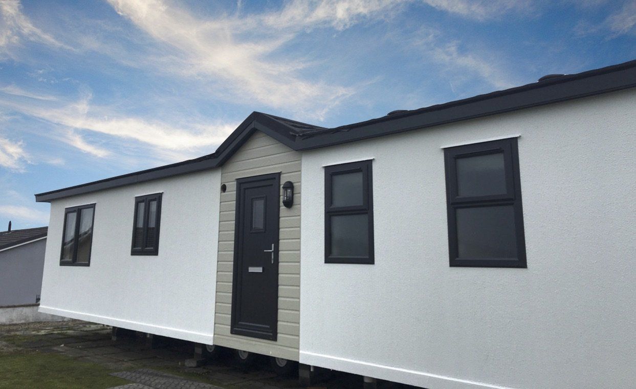 A white house with black windows and a black door.