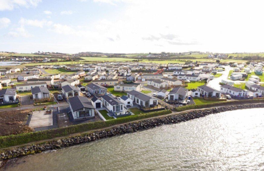 An aerial view of a residential area next to a body of water.