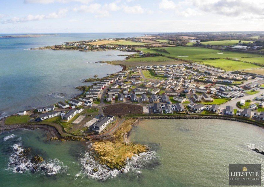 An aerial view of a residential area next to the ocean