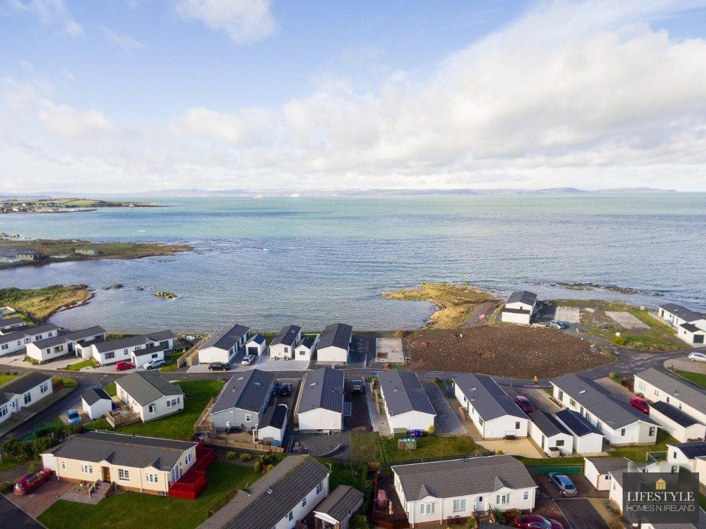 An aerial view of a row of houses next to a body of water.