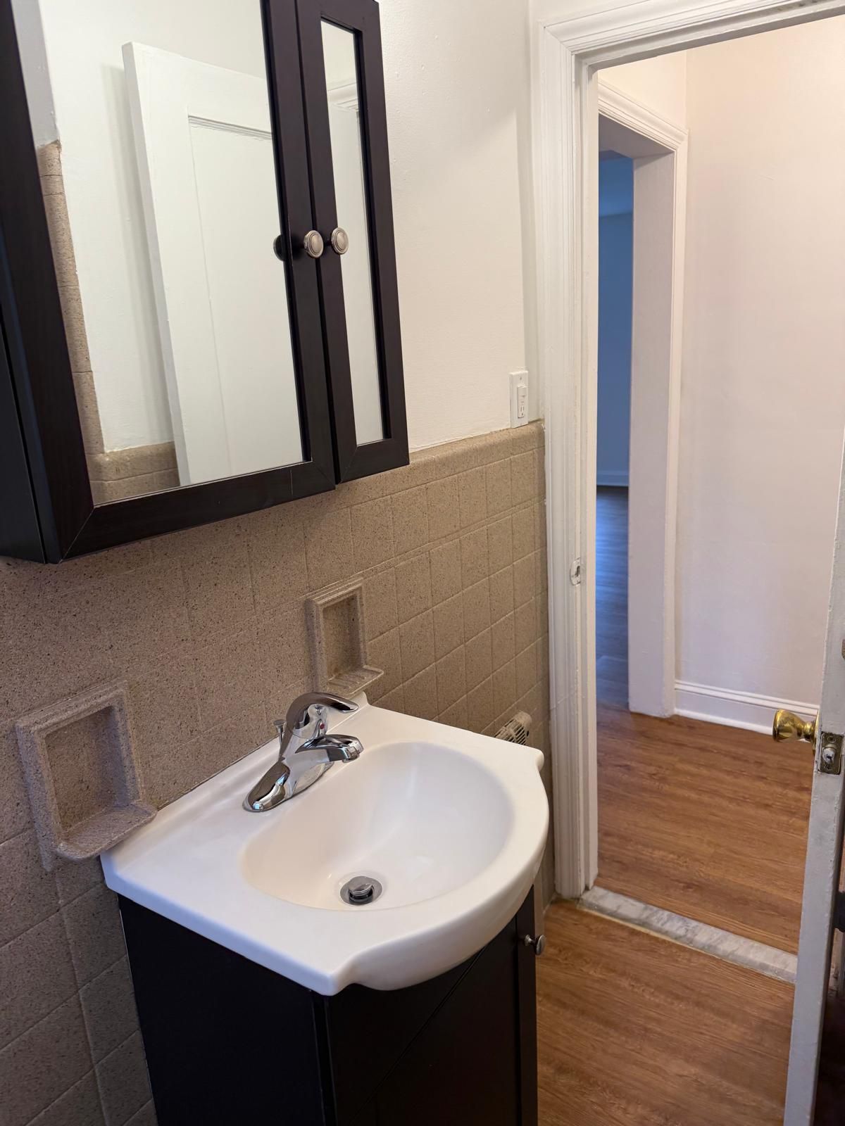 Bathroom vanity with mirror and sink in modern apartment