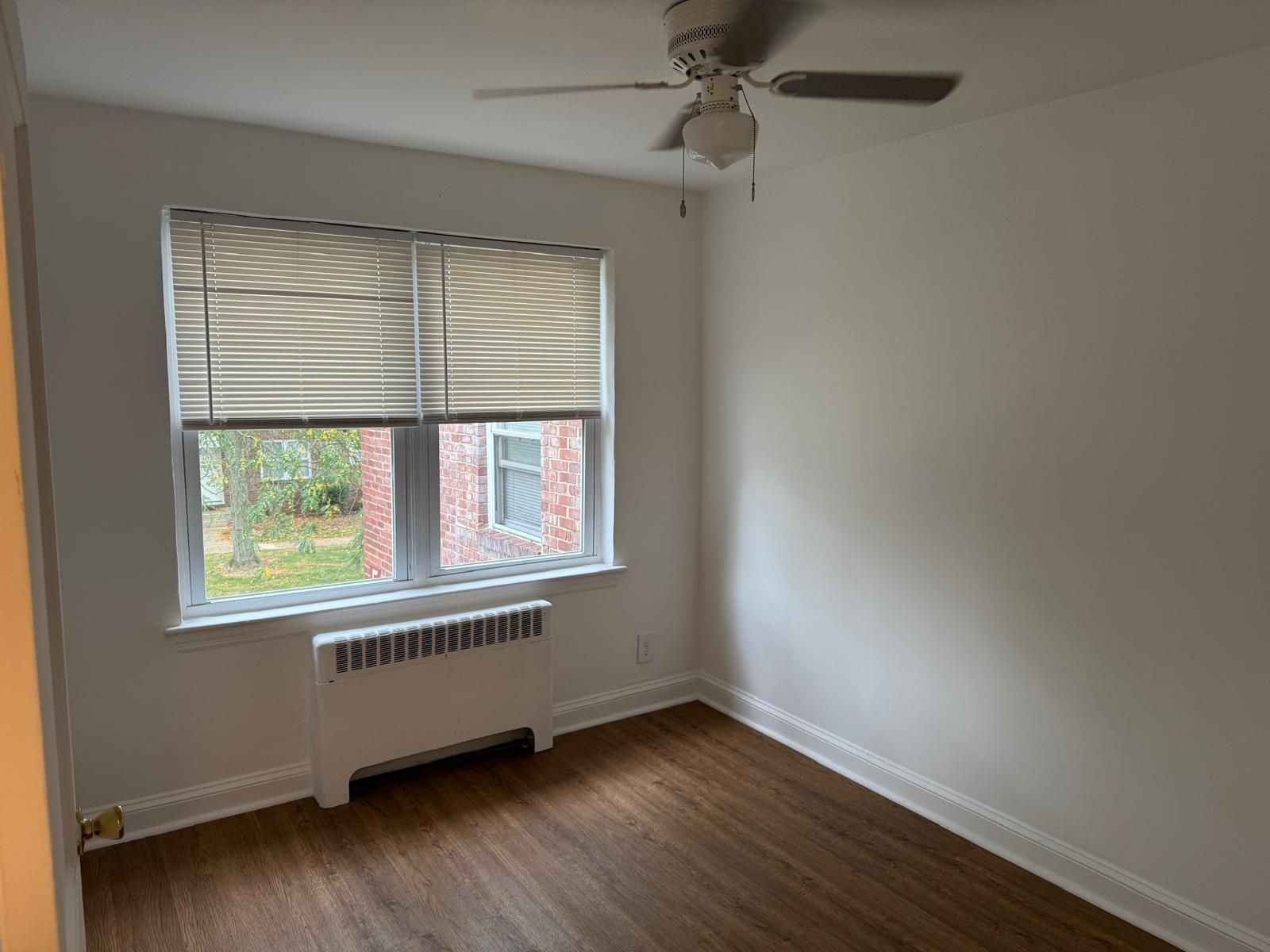 Bright living room with wooden floors and large window