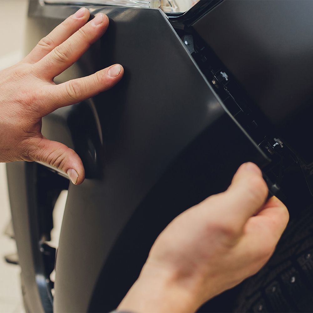 A close up of a person 's hand on a black object