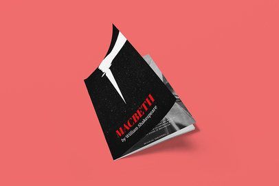 A book titled macbeth is floating in the air on a pink background.