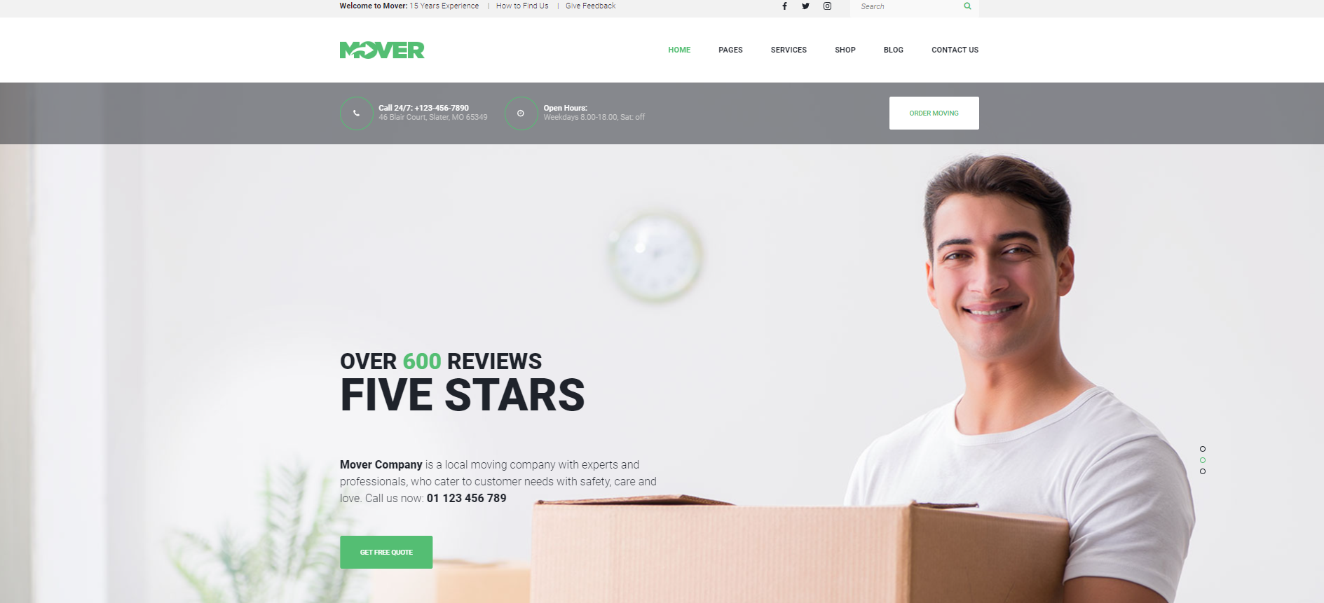 A man is holding a cardboard box in front of a website.