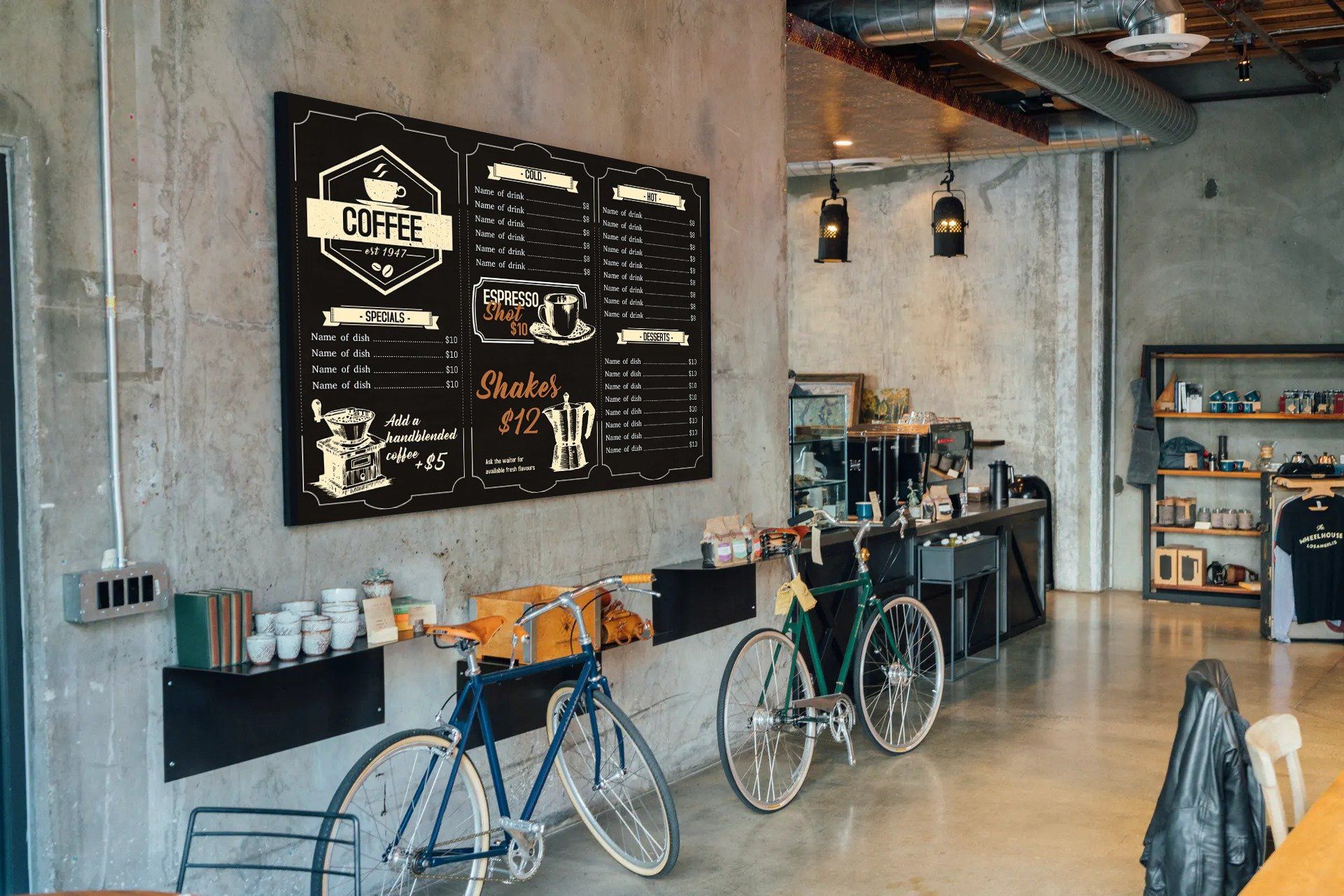 Two bicycles are parked in front of a chalkboard in a coffee shop.