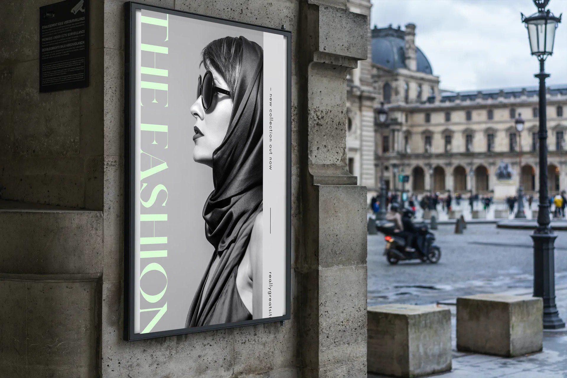 A poster of a woman wearing sunglasses is hanging on a wall.