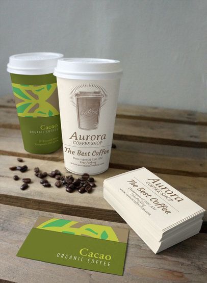 Aurora coffee shop cups and business cards on a wooden table