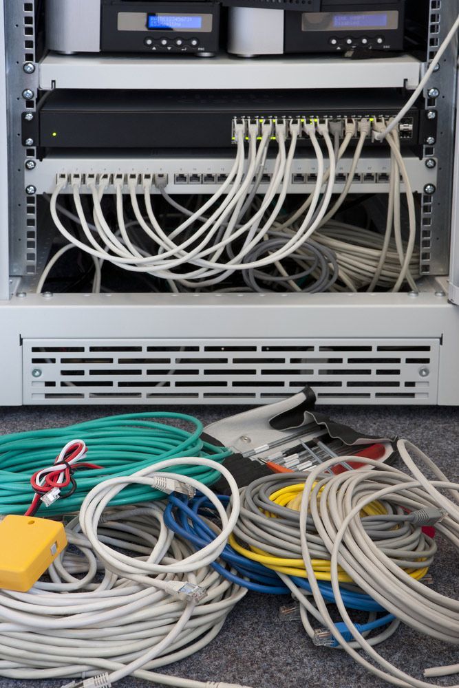 Network Server Rack With Connected Cables — A & J Electrical Contractors in Tamworth, NSW