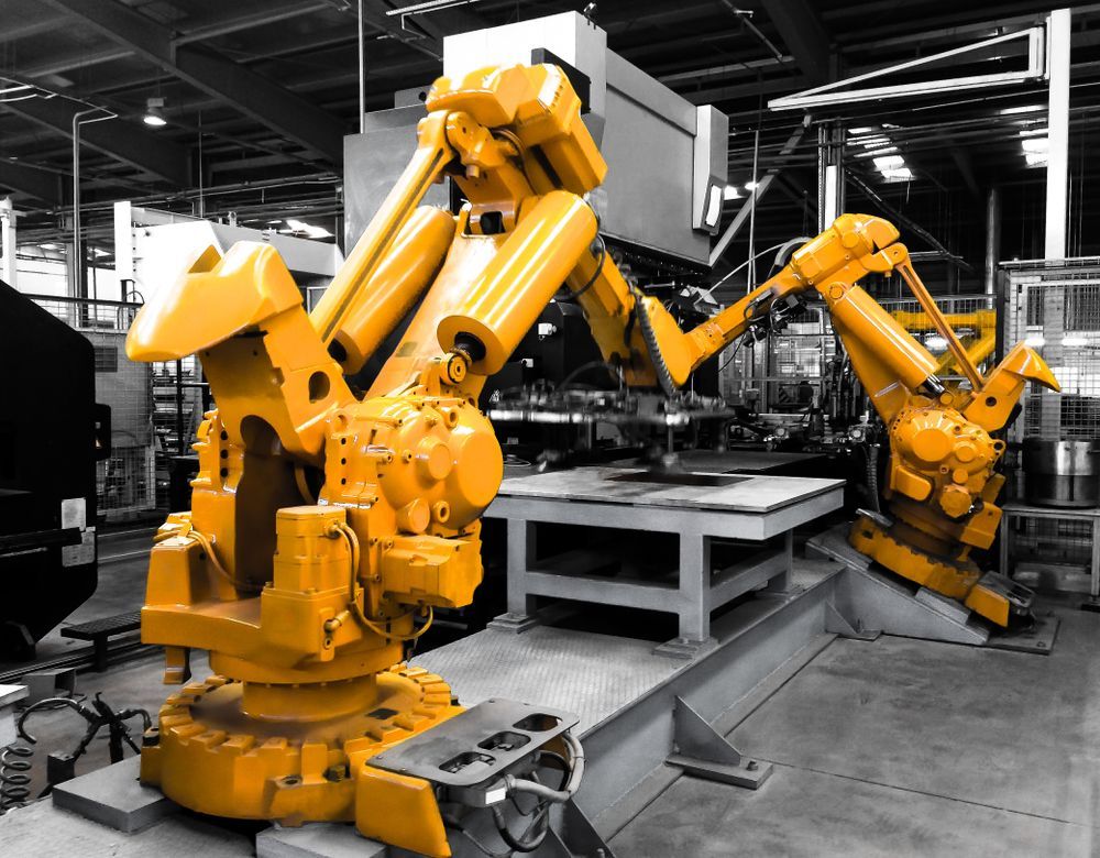 Yellow Industrial Robots Working in a Factory — A & J Electrical Contractors in Barraba, NSW