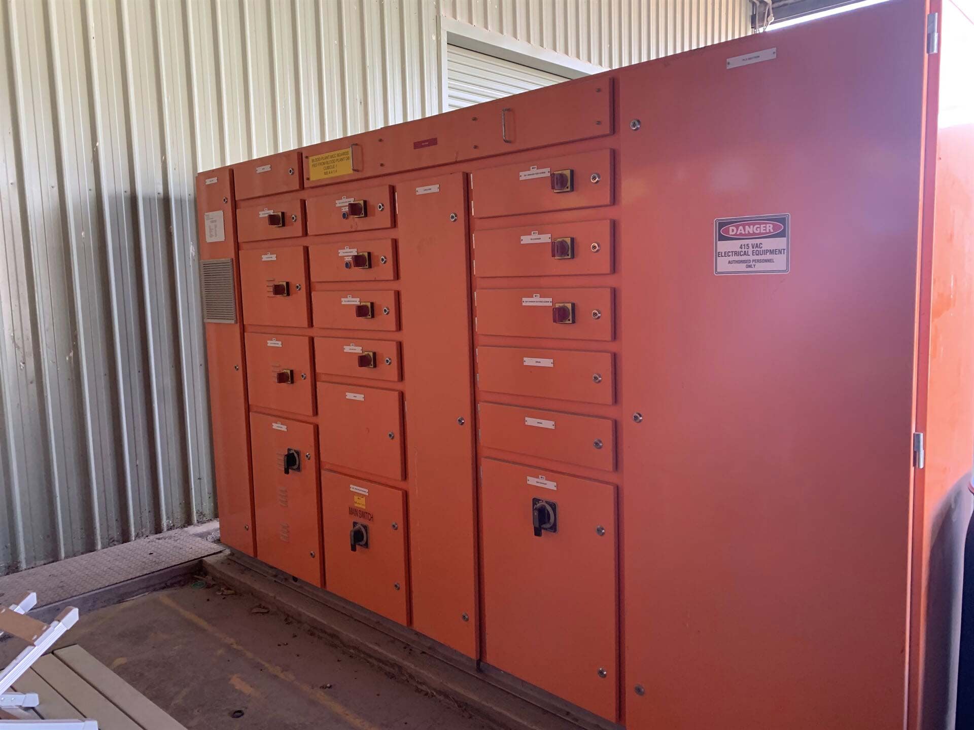 A Large Orange Electrical Panel Is Sitting Inside of A Building — A & J Electrical Contractors in Taminda, NSW